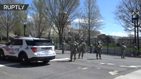 Police stand guard after vehicle rams barrier and injures officers at US Capitol.