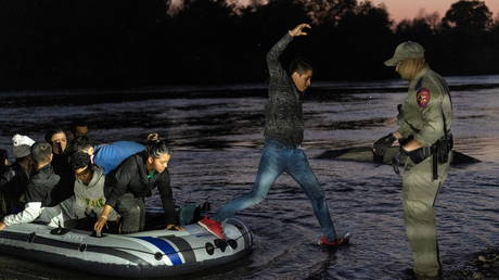 Migrants cross the Rio Grande river into the United States from Mexico in Roma, Texas, April 8, 2021.