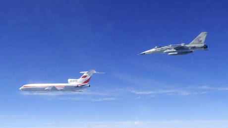 Taiwan's Ministry of National Defense, a Taiwanese Air Force Indigenous Defense Force (IDF) fighter aircraft, right, flies near a Chinese People's Liberation Army Air Force (PLAAF) TU-154 aircraft.