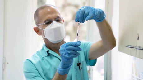 A medical technician at Serbia's 'Torlak' institute prepares to vaccinate Prime Minister Ana Brnabic, December 24, 2020.