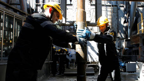 Employees work on drilling rig at Rosneft-owned Prirazlomnoye oil field outside Nefteyugansk, Russia