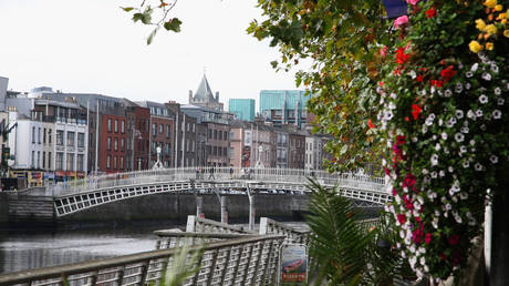 People walk over over Ha'penny Bridge on October 15, 2009 in Dublin, Ireland.