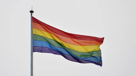 A pride flag waves in the wind in London