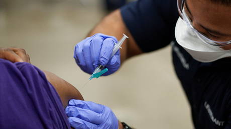 FILE PHOTO: A patient is injected with the Moderna Covid-19 vaccine at the Esports Stadium Arlington & Expo Center in Arlington, Texas.