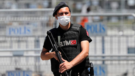 FILE PHOTO. A Turkish riot police officer stands guard in front of the Justice Palace in Istanbul, Turkey.