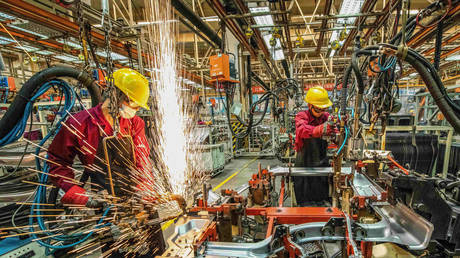 Employees work at a welding workshop in a car factory in Weifang in China's eastern Shandong province