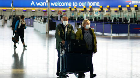 People wearing masks are seen at Heathrow airport, as the spread of the coronavirus disease (COVID-19) continues, London, Britain, April 5, 2020.