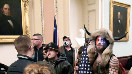 FILE PHOTO: Jacob Chansley, also known as the 'QAnon Shaman,' stands with other supporters of then-President Donald Trump as they demonstrate on the second floor of the US Capitol, January 6, 2021.