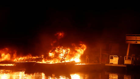 Boats engulfed in flames are seen at a dock near Markley Cove Resort during the LNU Lighting Complex Fire on the outskirts of Napa, California, U.S., August 19, 2020.