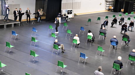 FILE PHOTO. People wait to be vaccinated against Covid-19 at the vaccination site in Nord Arena in Frederikshavn, Jutland, Denmark. © AFP / Henning Bagger