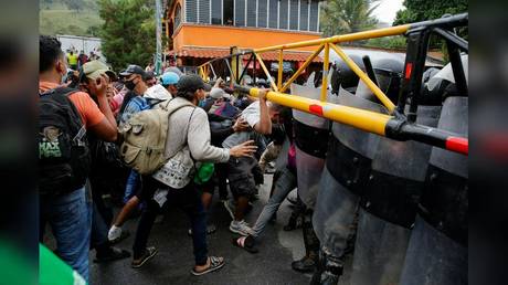 A caravan of Honduran migrants is shown in January trying to cross the border into Guatemala on their trek toward the US.