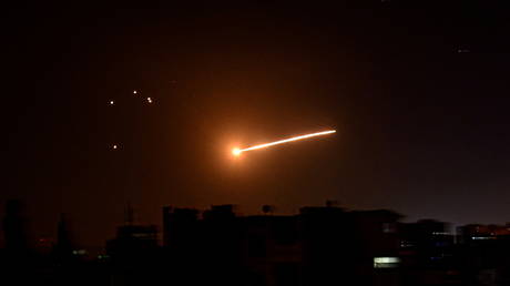 FILE PHOTO: A missile streaks across the night sky in Syria during an Israeli strike, February 24, 2020.