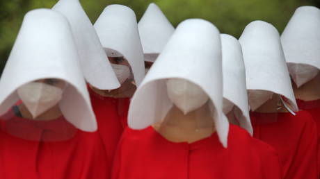 Activists dressed in Handmaid's Tale costumes walk as they take part in a demonstration to mark International Women's Day in Sao Paulo, Brazil March 8, © REUTERS/Carla Carniel