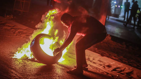 Palestinians burn tires during a demonstration condemning overnight clashes in East Jerusalem.