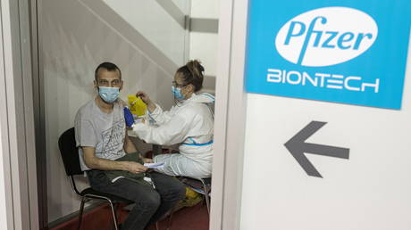 FILE PHOTO: A man receives a dose of the Pfizer-BioNTech coronavirus vaccine.