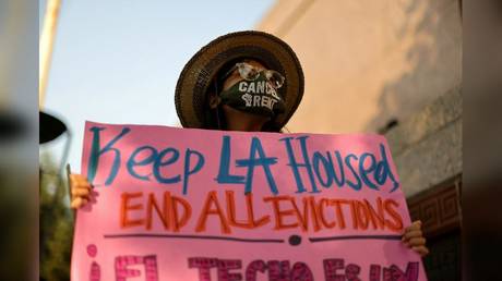 A protester is shown in Los Angeles last August opposing a wave of evictions. With home prices rising and Covid-19 lockdowns wiping out jobs, increasing numbers of Californians can no longer afford to live in the state.