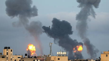 Flames and smoke rise during Israeli air strikes amid a flare-up of Israel-Palestinian violence, in the southern Gaza Strip on May 11, 2021.