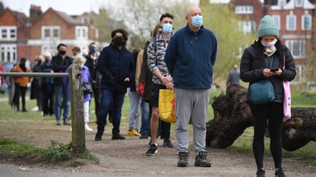 People stand in line for coronavirus surge testing on Clapham Common, south London.