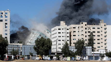 A tower housing AP, Al Jazeera offices collapses after Israeli missile strikes in Gaza city, May 15, 2021