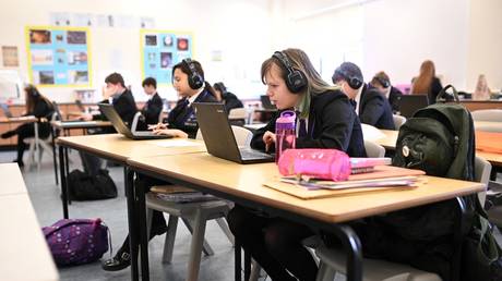 Year 9 students take part in an online class at Park Lane Academy in Halifax, northwest England on March 4, 2021.