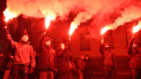 Kiev residents fire flares as they participate in a memorial rally dedicated to the 7th anniversary of the Maidan revolution in Kiev, Ukraine.