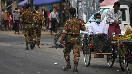 Soldiers search for protesters, who were taking part in a demonstration against the military coup, in Yangon, Myanmar on May 6, 2021