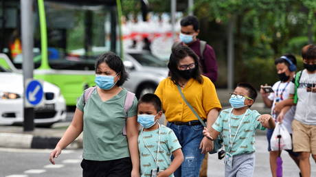 People wearing face masks cross a road amid the coronavirus disease outbreak in Singapore on May 14, 2021.