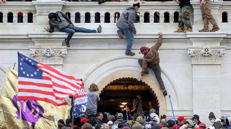 FILE PHOTO: A mob of Donald Trump's supporters fight with members of law enforcement as they storm the US Capitol Building in Washington, DC, January 6, 2021 © Reuters / Leah Millis