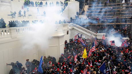 FILE PHOTO: Police release tear gas into a crowd of pro-Trump protesters during a riot at the US Capitol building, January 6, 2021.