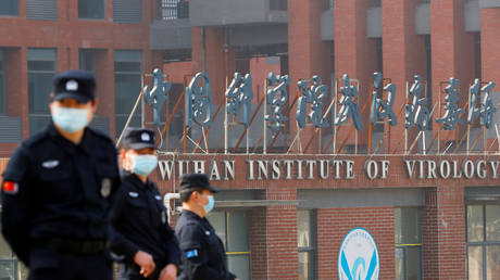 FILE PHOTO: Security personnel keep watch outside the Wuhan Institute of Virology during a visit by a World Health Organization team, in Wuhan, China, February 3, 2021.