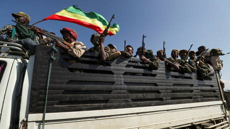 FILE PHOTO: Amhara region militiamen ride on their truck as they head to face the Tigray People's Liberation Front in Sanja