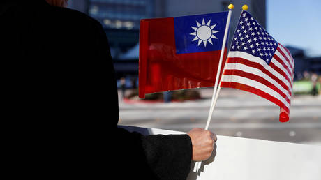 A demonstrator holds flags of Taiwan and the United States in support of Taiwanese President Tsai Ing-wen