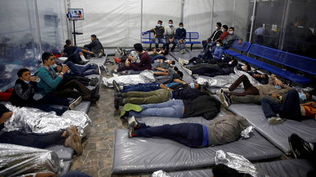 Young migrants lie inside a pod at the Donna Department of Homeland Security holding facility, the main detention centre for unaccompanied children in the Rio Grande Valley run by U.S. Customs and Border Protection, in Donna, Texas, Tuesday, March 30, 2021. © Dario Lopez-Mills / Pool via REUTERS