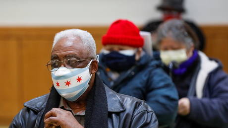 A Chicago resident wearing a face mask in the colors of the city's flag waits to get the Covid-19 vaccine in this February 13, 2021 file photo.