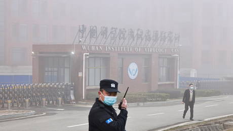 FILE PHOTO: Security personnel stand outside the Wuhan Institute of Virology as members of the World Health Organization (WHO) team tasked with investigating the origins of Covid-19 arrive for a visit, in Wuhan, China, February 3, 2021.