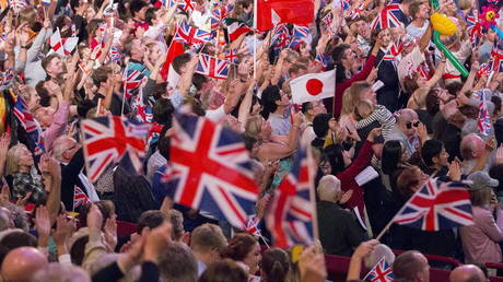 Revellers wave flags during the last night of the BBC Proms festival of classical music at the Royal Albert Hall in London, Britain (FILE PHOTO) © REUTERS/Neil Hall