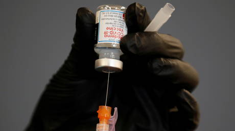 FILE PHOTO: A health care worker fills a syringe with a dose of Moderna's coronavirus vaccine, in Chula Vista, California.