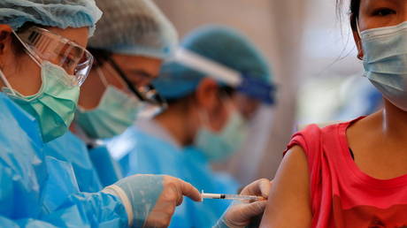 FILE PHOTO. A woman receives coronavirus vaccine in Bangkok, Thailand.