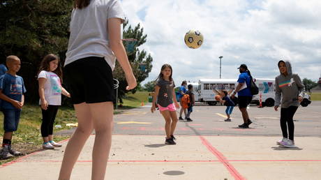 FILE PHOTO: Children play outside at a YMCA summer camp, in Farmington Hills, Michigan, June 23, 2020.