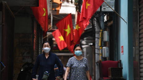 Women on a street in Hanoi, Vietnam, May 23, 2021. © Nhac Nguyen / AFP