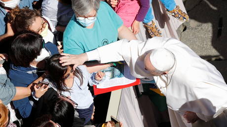 Pope Francis greets people at the San Damaso courtyard after the weekly general audience at the Vatican on May 26, 2021.