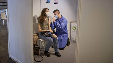 A Pompier (French Fireman) administers a Covid-19 vaccination in Paris on May 12, 2021 in Paris, France