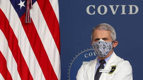 Dr. Anthony Fauci is shown double-masking at a White House event in February, after being vaccinated against Covid-19.