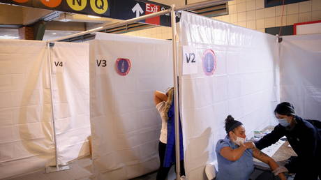 Commuter receives Johnson & Johnson vaccine at a subway station in the Brooklyn borough of New York City