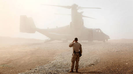 FILE PHOTO: A US Marine watches as an Osprey aircraft lands at Forward Operating Base Shukvani, Afghanistan.