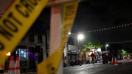 Police investigate the scene of a mass shooting in the Sixth Street entertainment district area of Austin, Texas, US, June 12, 2021