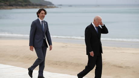 Joe Biden and Justin Trudeau walk along the boardwalk during the G7 summit in Carbis Bay, Cornwall, Britain