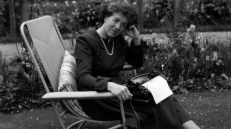 Children's writer Enid Blyton (1897 - 1968) sitting in her garden in Beaconsfield, Buckinghamshire. © George Konig/Getty Images