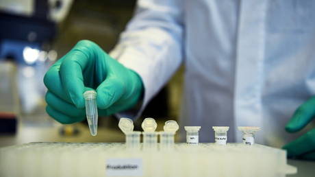 FILE PHOTO: An employee of German biopharmaceutical company CureVac working on a Covid-19 vaccine in Tuebingen, Germany, March 12, 2020