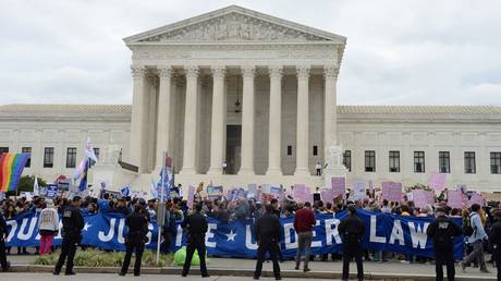 FILE PHOTO: LGBTQ activists are shown rallying outside the US Supreme Court in October 2019.